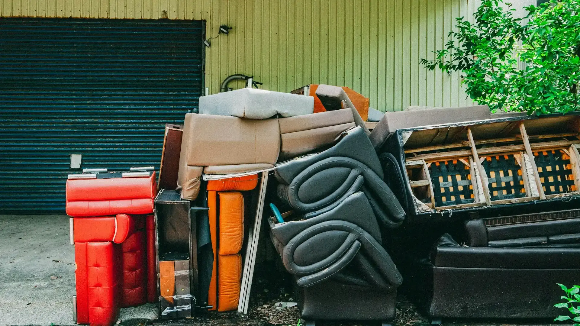 Pile of old couches and furniture waiting to be hauled away