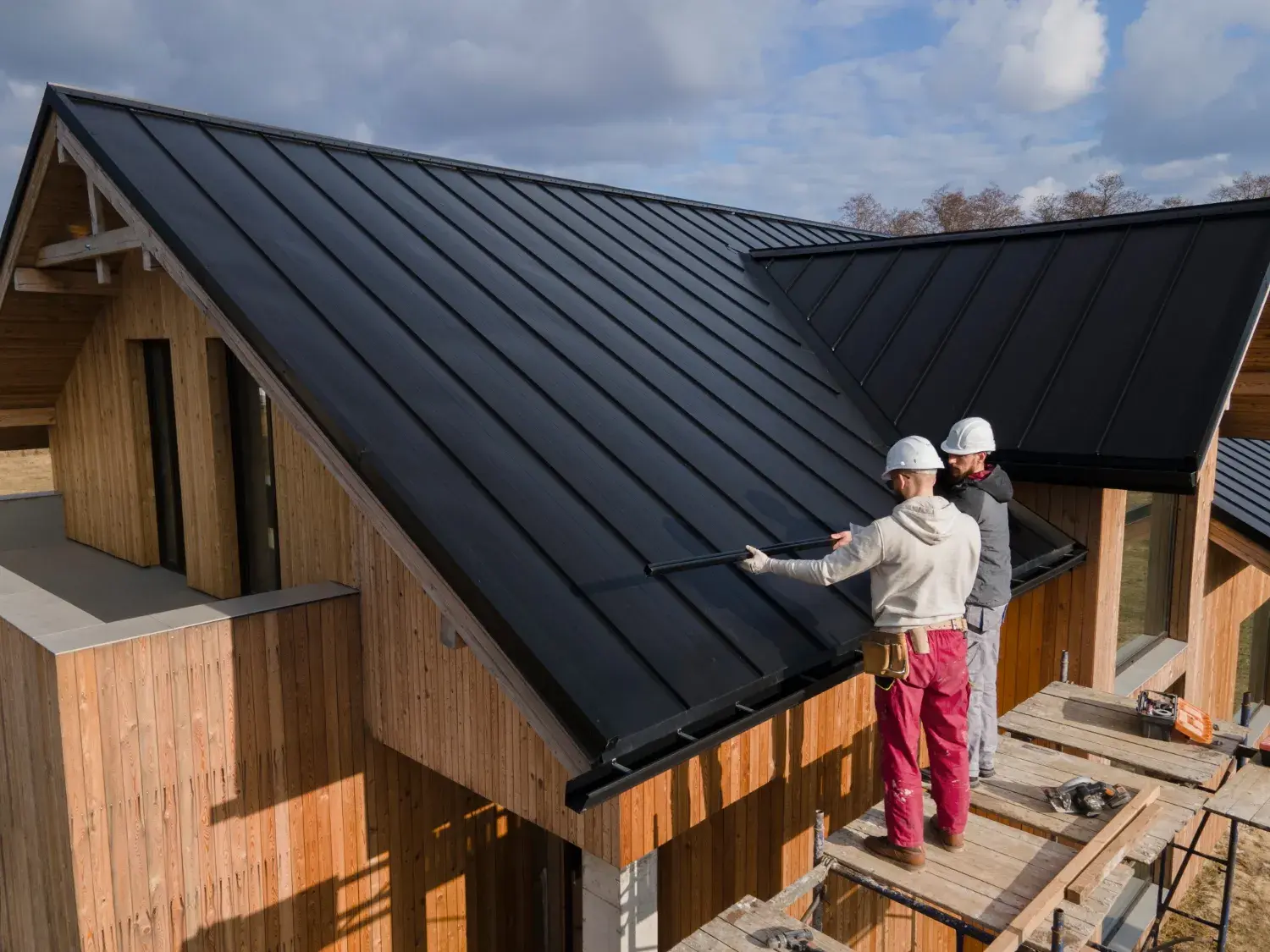 Roofing estimator pointing out work on a home's roof