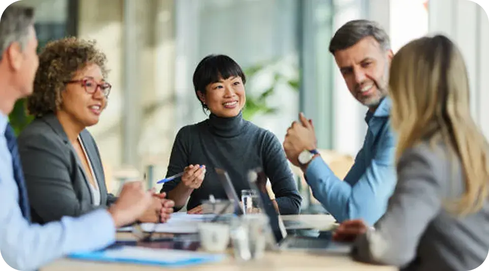 Business team in a meeting discussing plans at a conference table Business team in a meeting discussing plans at a conference table